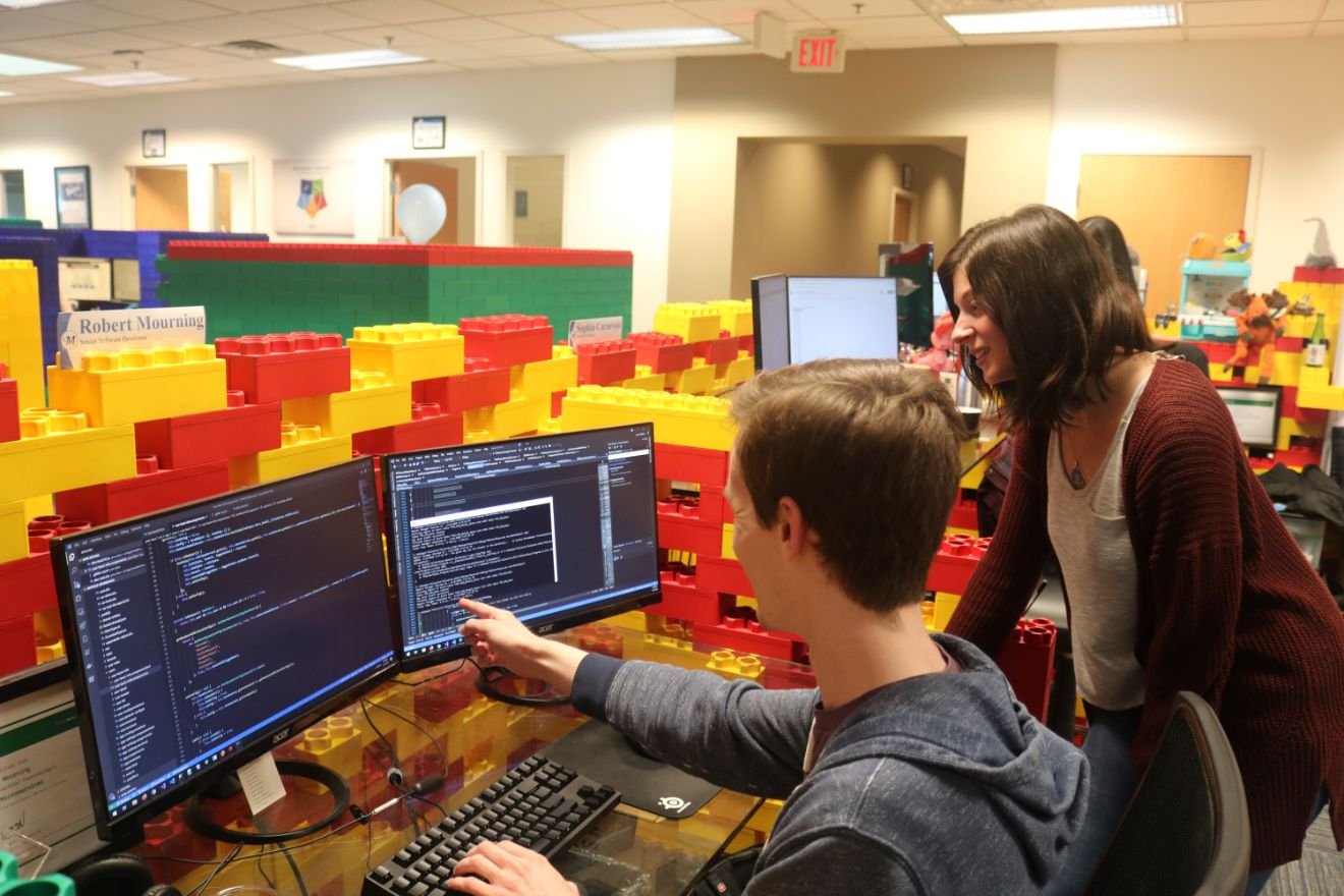 Software team members having a discussion at the computer