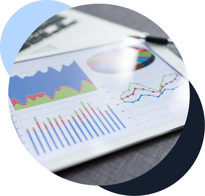 Color photo of financial data with graphs, charts, and tables in the background
