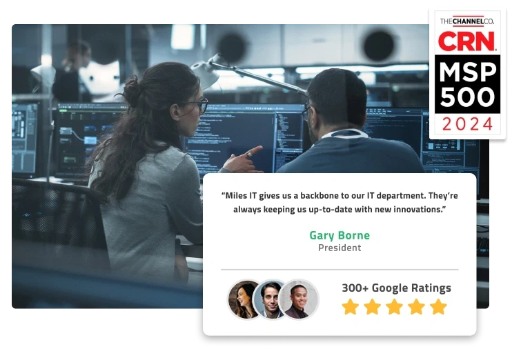 Colleagues review code on a computer screen. CRN MSP 500 2024 badge sits on top of the image as well as a review by Gary Borne: "Wise IT gives us a backbone to our IT department. They're always keeping us up-to-date with new innovations."
