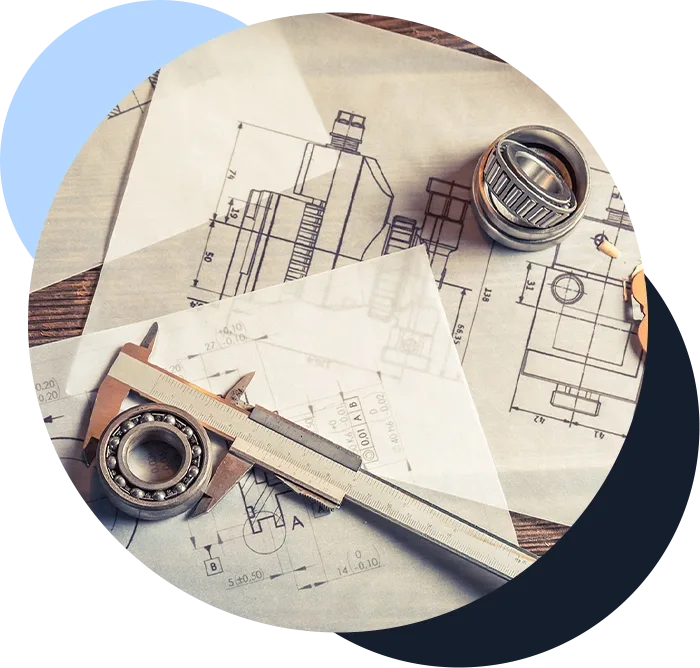 Engineering schematics and various tools on a table