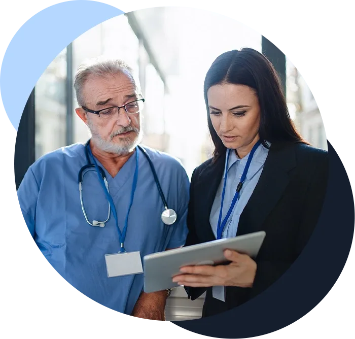 Doctor and administrative worker looking at digital patient chart