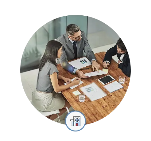 Miles IT referral program - people from the referring company look at a series of reports and devices together in an office