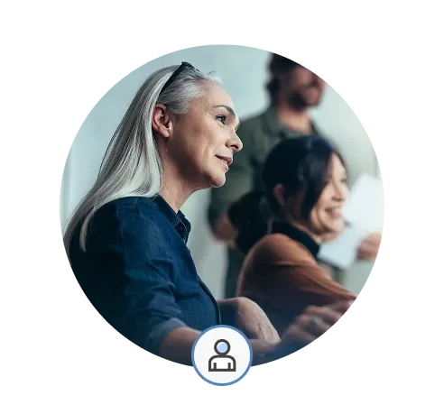 Miles IT referral program - referring person looks at colleagues in a meeting